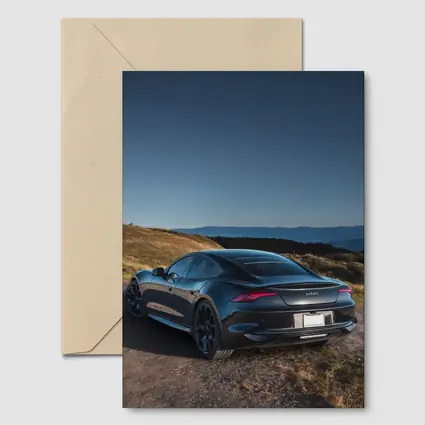 Karma Revero Dark Sedan Hillside Blue Sky