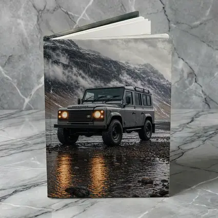 Land Rover Defender Parked On Rocky Shore