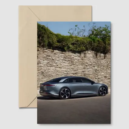 Lucid Air Sedan Parked By Stone Wall