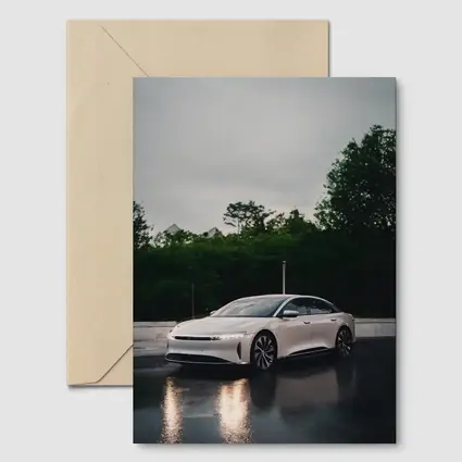 Lucid Air White Sedan Rainy City Street