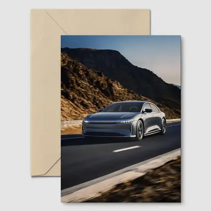 Lucid Air Speeding Through Rocky Mountain Road