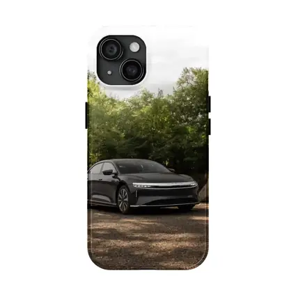 Lucid Air Dark Sedan Parked Among Trees