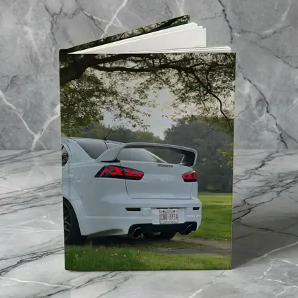 Mitsubishi Lancer White Parked Under Green Trees