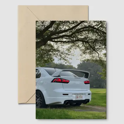Mitsubishi Lancer White Parked Under Green Trees