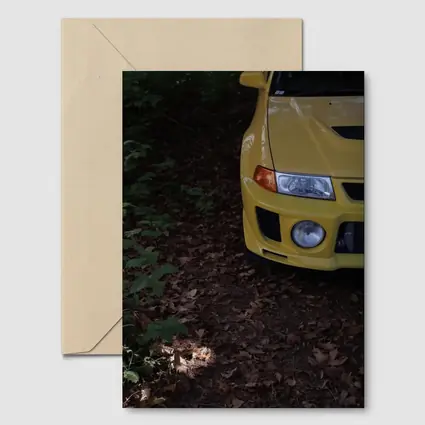 Yellow Mitsubishi Lancer Evolution Forest Trail