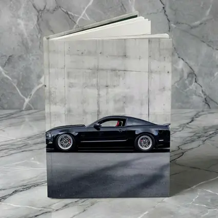 Black Ford Mustang Against Concrete Wall
