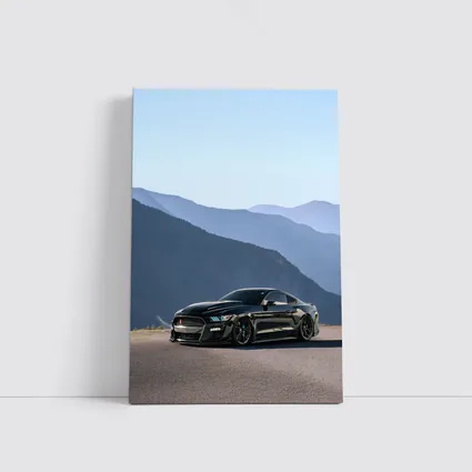 Black Ford Mustang Parked Against Mountain Backdrop