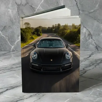 Black Porsche 911 Driving Open Road