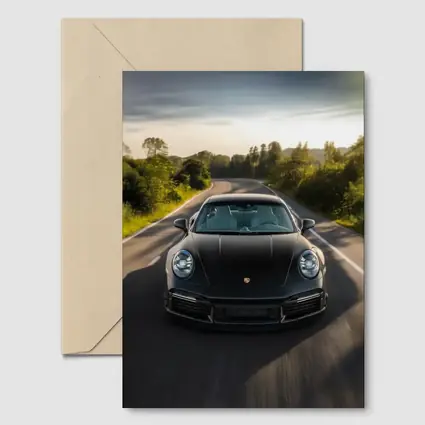 Black Porsche 911 Driving Open Road