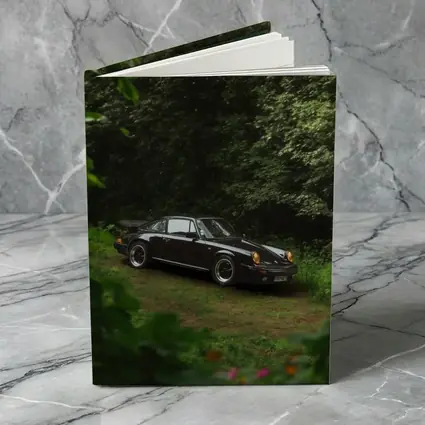 Black Porsche 911 Parked in Green Forest