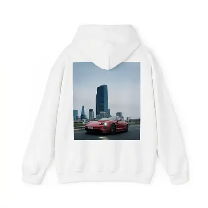 Red Porsche Taycan Driving Through City Skyline