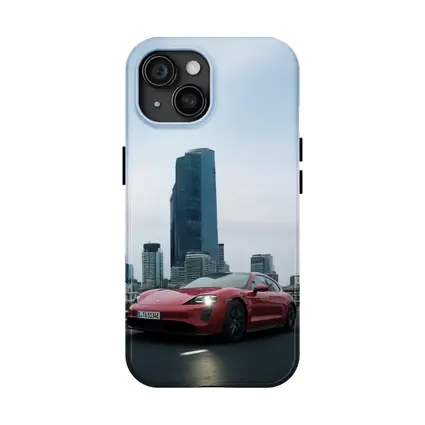 Red Porsche Taycan Driving Through City Skyline
