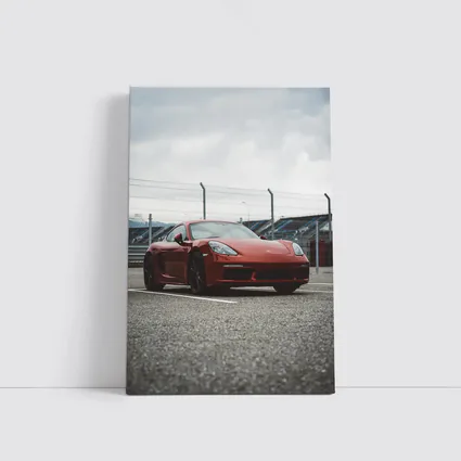 Red Porsche Cayman at Racing Circuit Track