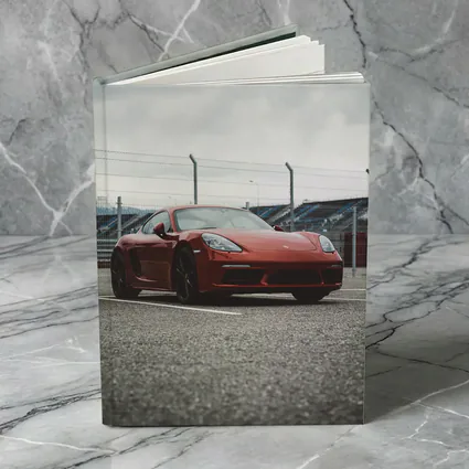 Red Porsche Cayman at Racing Circuit Track