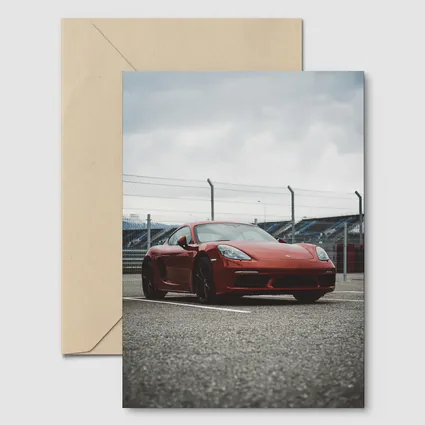 Red Porsche Cayman at Racing Circuit Track