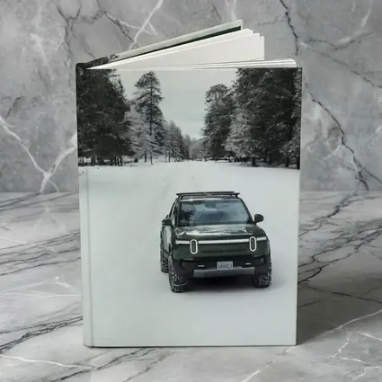 Rivian R1S Green Truck Snowy Forest Road