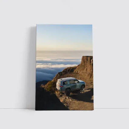 Rivian R1S SUV Above Mountain Clouds