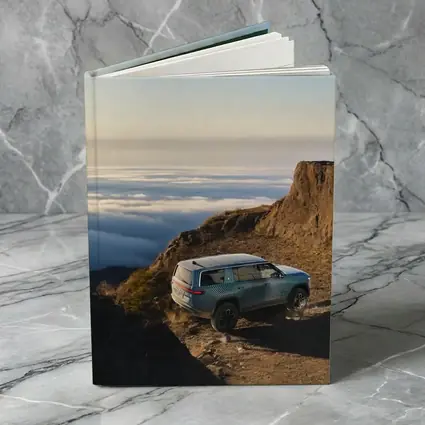 Rivian R1S SUV Above Mountain Clouds