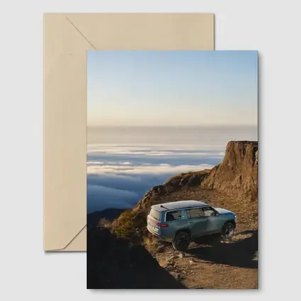 Rivian R1S SUV Above Mountain Clouds