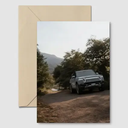 Rivian R1T Electric Truck Dirt Road Forest