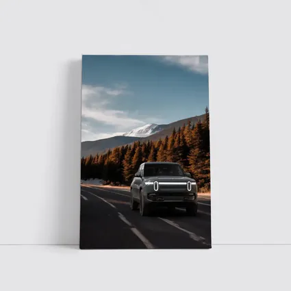 Rivian R1S on Mountain Road Forest Background
