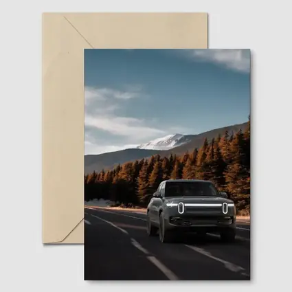 Rivian R1S on Mountain Road Forest Background