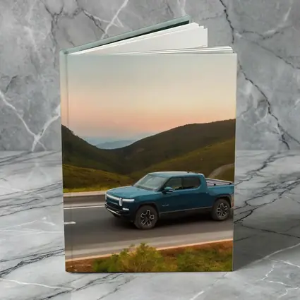 Rivian R1T Truck Rolling Through Mountain Valley