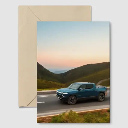 Rivian R1T Truck Rolling Through Mountain Valley