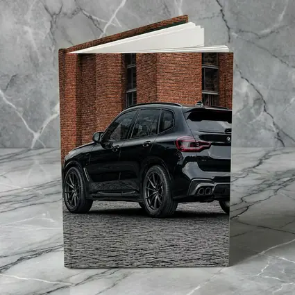 Black BMW X5M Parked Near Brick Building