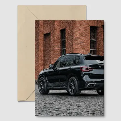 Black BMW X5M Parked Near Brick Building