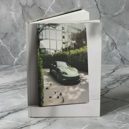 Green Porsche Taycan Parked By Glass Building