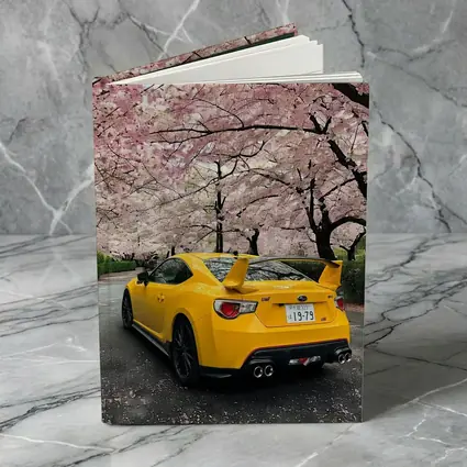 Yellow Subaru BRZ Under Cherry Blossoms