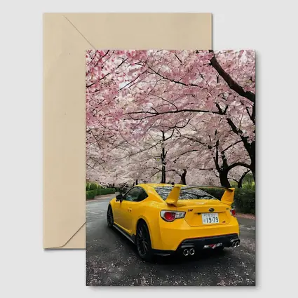 Yellow Subaru BRZ Under Cherry Blossoms