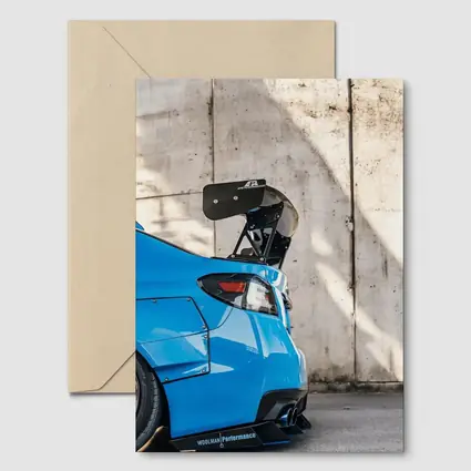 Subaru WRX Blue Carbon Wing Concrete Wall