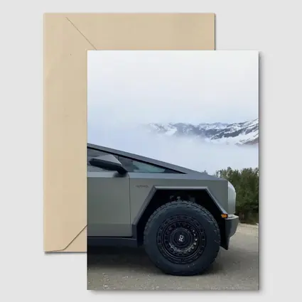 Tesla Cybertruck Parked Near Snowy Mountain Fog