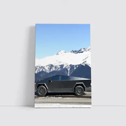 Tesla Cybertruck Parked Against Snowy Mountains