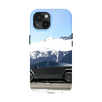 Tesla Cybertruck Parked Against Snowy Mountains