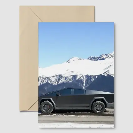 Tesla Cybertruck Parked Against Snowy Mountains