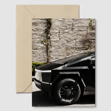 Tesla Cybertruck Black Against Stone Wall