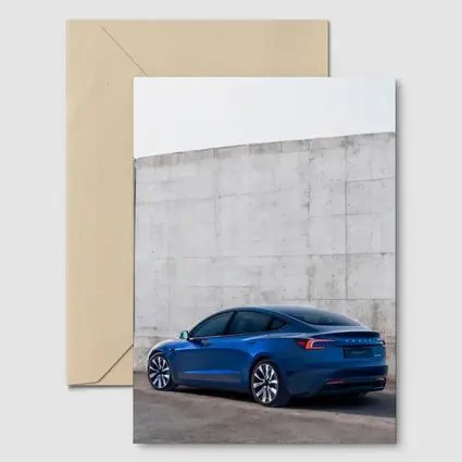 Tesla Model 3 Blue Against Concrete Wall